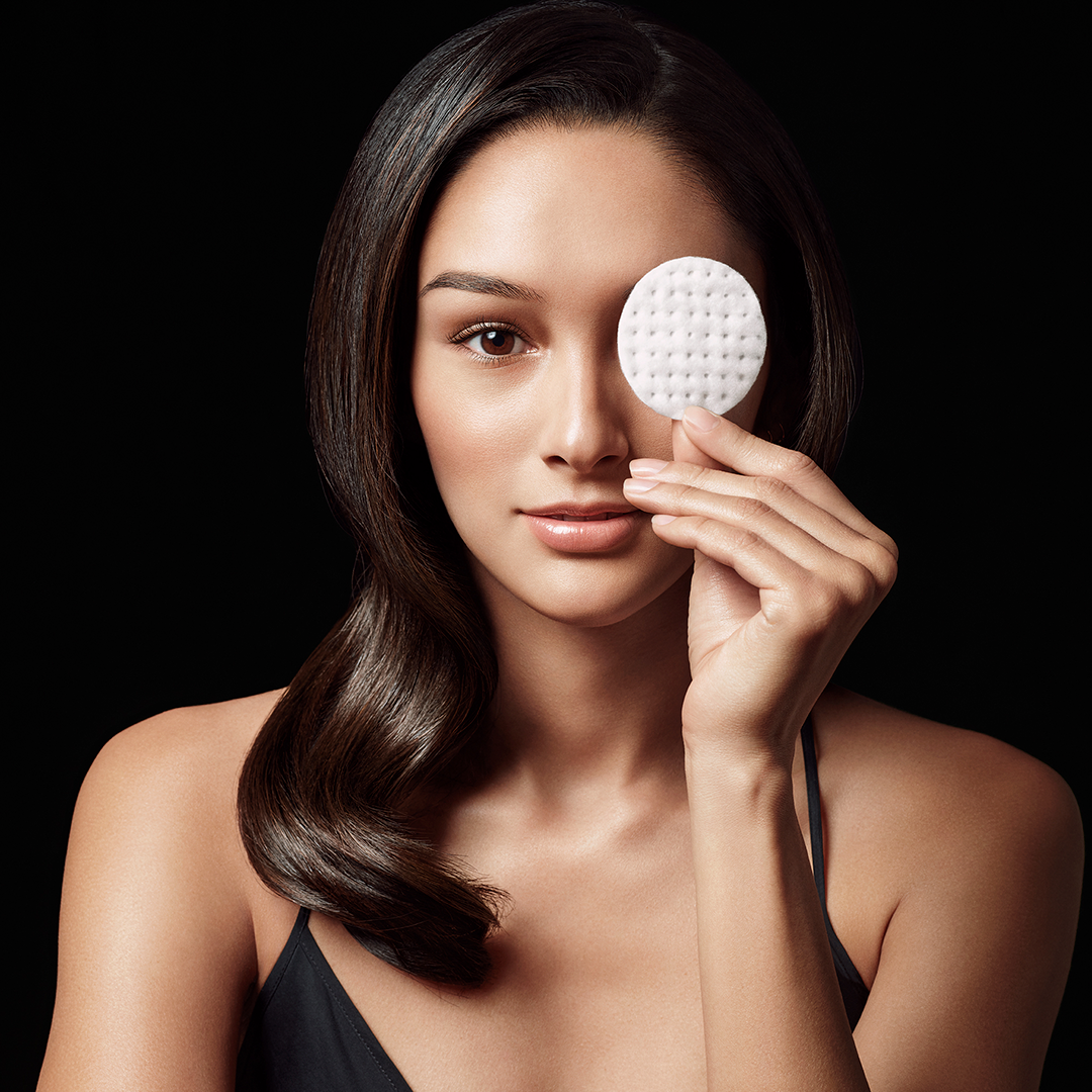 Image of model holding up a cotton pad