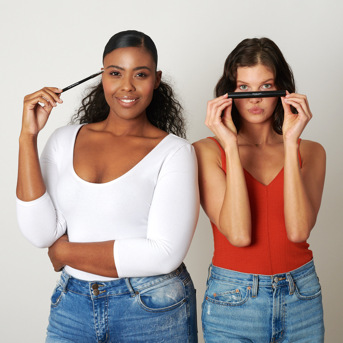 Image of model Alexus holding Hi-Def Brow Pencil and Kimee holding Double-Ended Volume Set