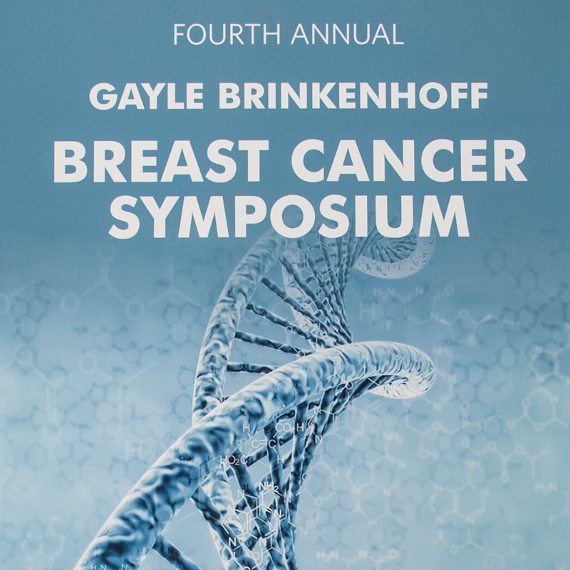 Image of 4th annual breast cancer symposium background image on blue background with science theme