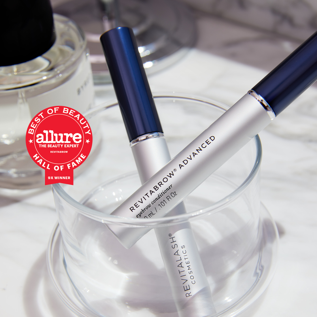 Image of 2 RevitaBrow Advanced tubes in a clear beaker. Also displayed is an Allure award seal for Best of Beauty Hall of Fame 9x Winner