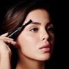Image of model applying Hi-Def Brow Gel to her eyebrows