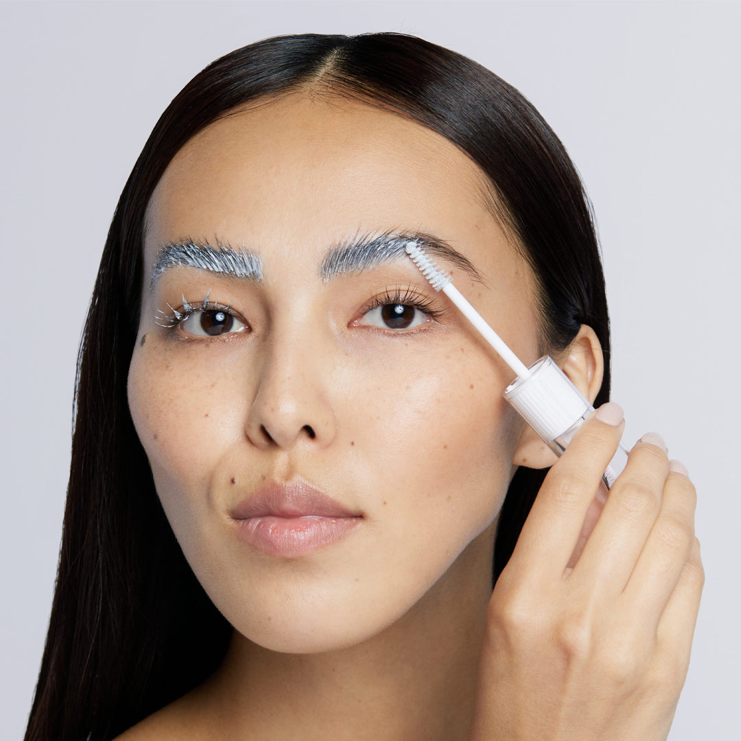 Image of model applying Lash & Brow Masque to her eyebrows