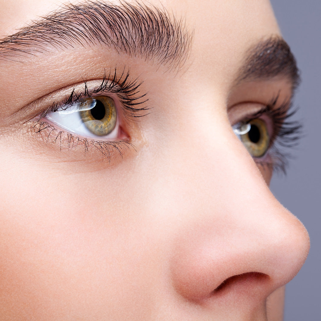 Close up image of model's beautiful eyes and bold brows.