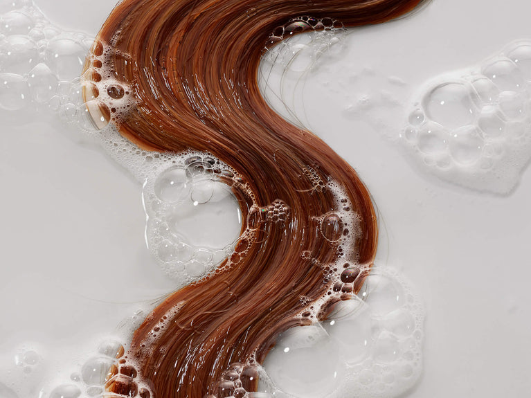 Wet red hair with thickening shampoo suds