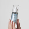 Image of a hand holding up a bottle of AquaBlur Hydrating Eye Gel and Primer