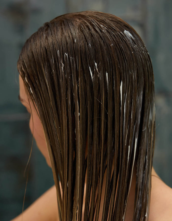 Person with wet, conditioned hair