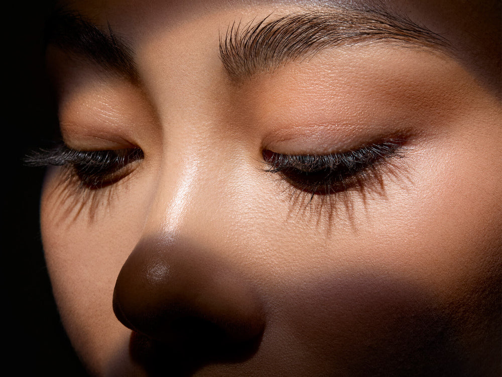 Close-up of a person's face with a focus on the eyes and nose. 25% off sitewide $100 purchase.