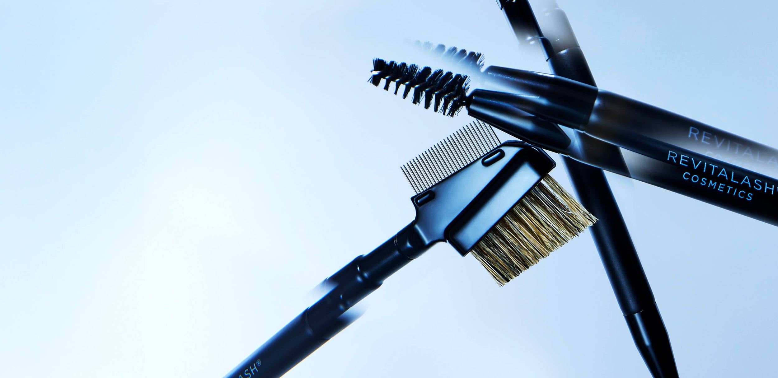 Eyebrow grooming tools with brush and pencil on a blue background