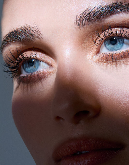 Close-up of a person's face with blue eyes and brown hair.