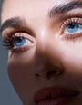 Close-up of a person's face with blue eyes and brown hair.
