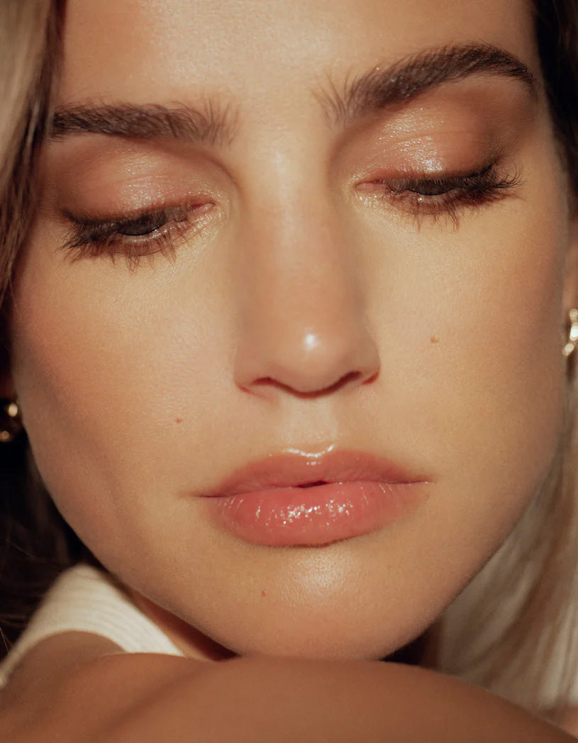model with thick brows looking down