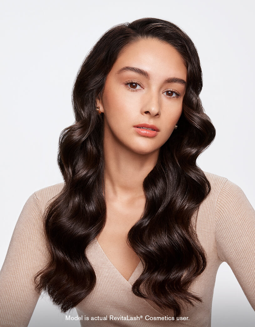 Model with thick, wavy styled hair