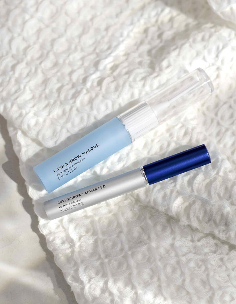 Lash & Brow Masque and RevitaBrow on a white textured surface