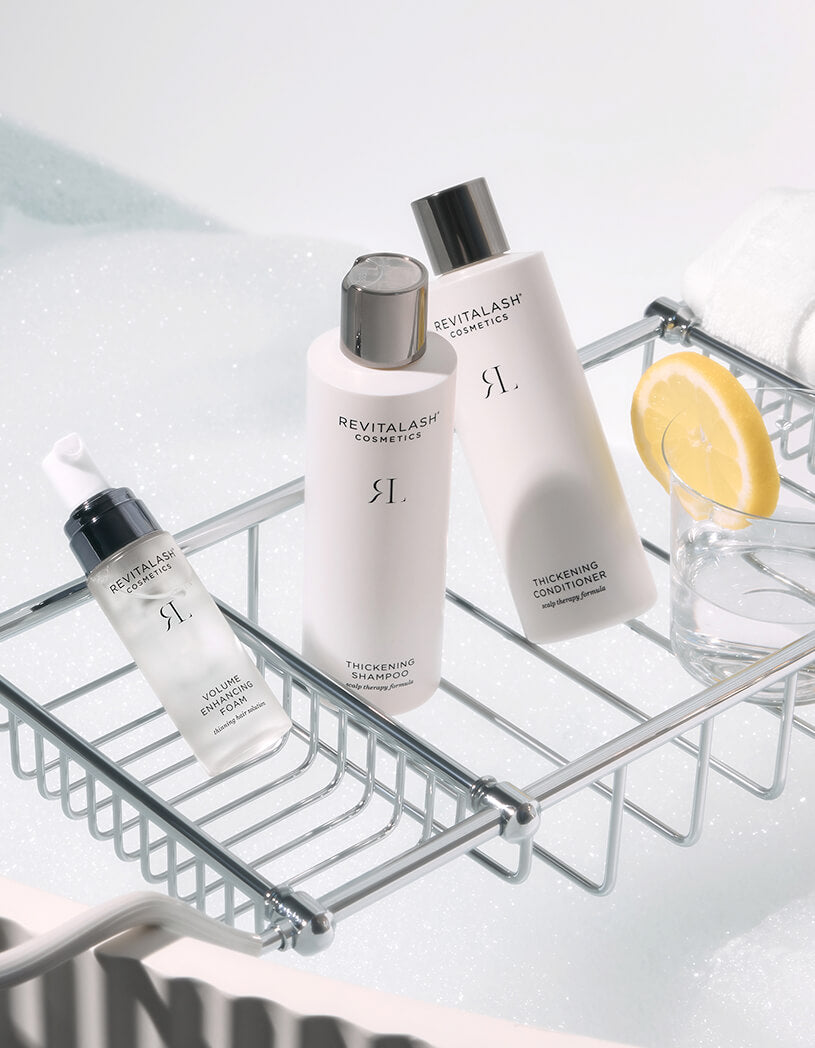 Revitalash thickening hair products on a metal shelf with a white background