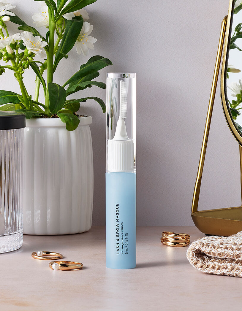 Blue and white cosmetic tube on a table with decorative items