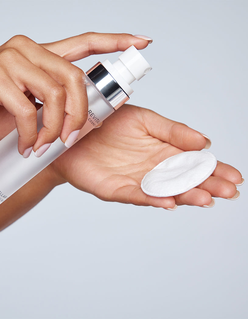 Person spraying MWLW  onto their cotton pad against a light gray background