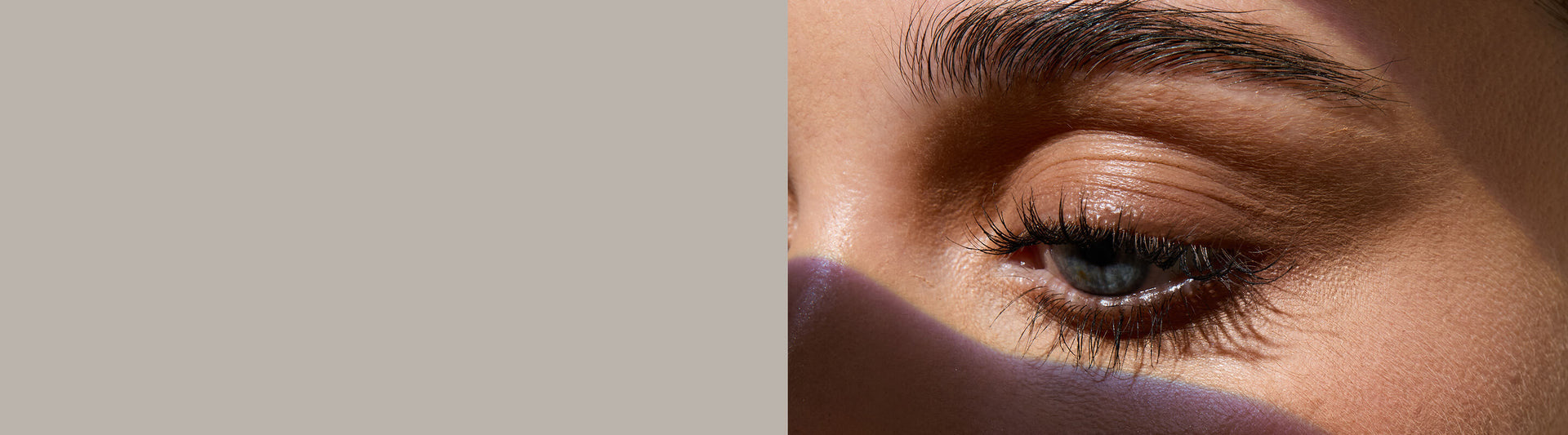 Close-up of a person's eye with a blurred background. Model is actual RevitaLash® Cosmetics user. 25% off sitewide $100 purchase.