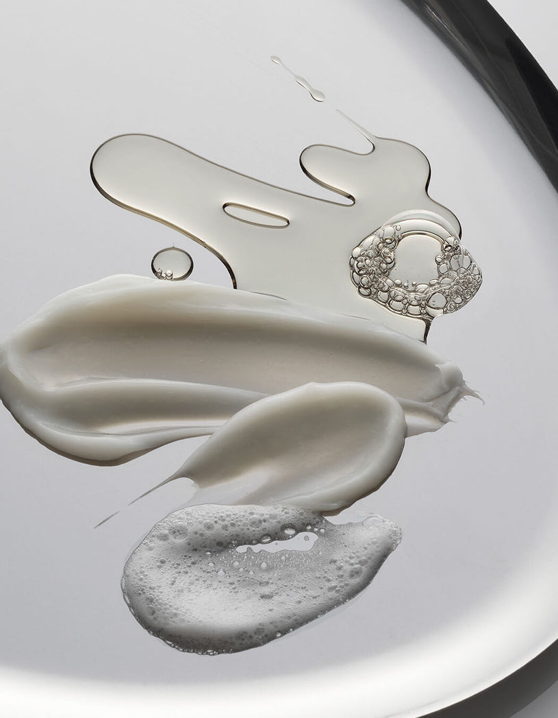 Close-up of volumizing hair collection elements on a reflective surface
