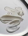 Close-up of volumizing hair collection elements on a reflective surface
